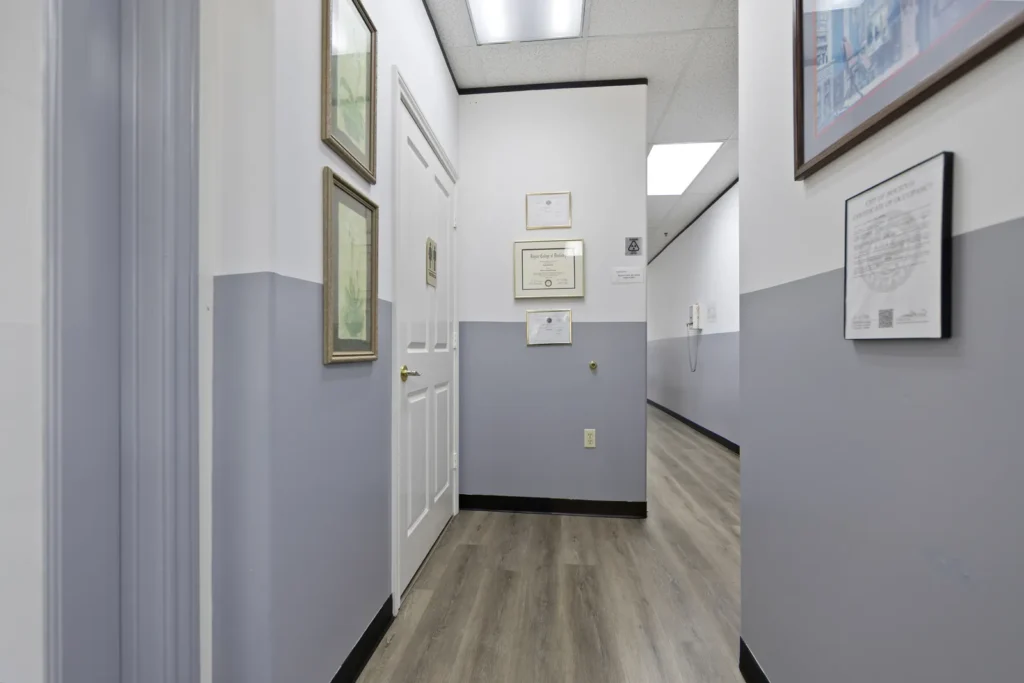 Diplomas lining the hallway at Next Care Dental